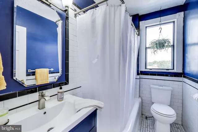 a bathroom with a sink toilet a mirror and shower