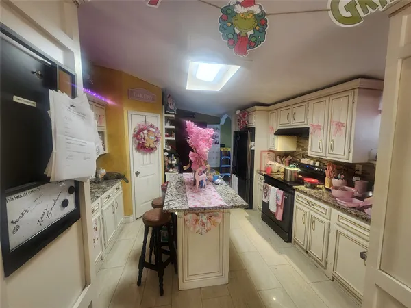 a kitchen with counter top space appliances and cabinets