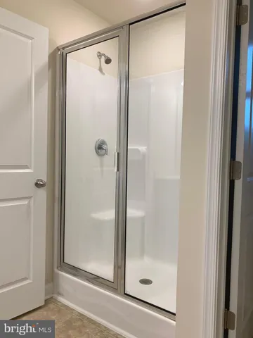a bathroom with a glass shower door