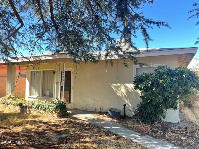 a backyard of a house with yard and outdoor seating