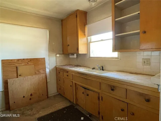a kitchen with a refrigerator and stove