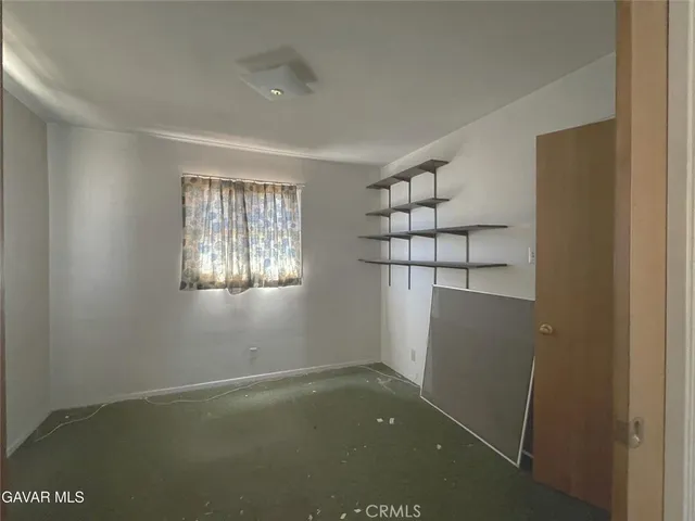 a view of a house with wooden fence