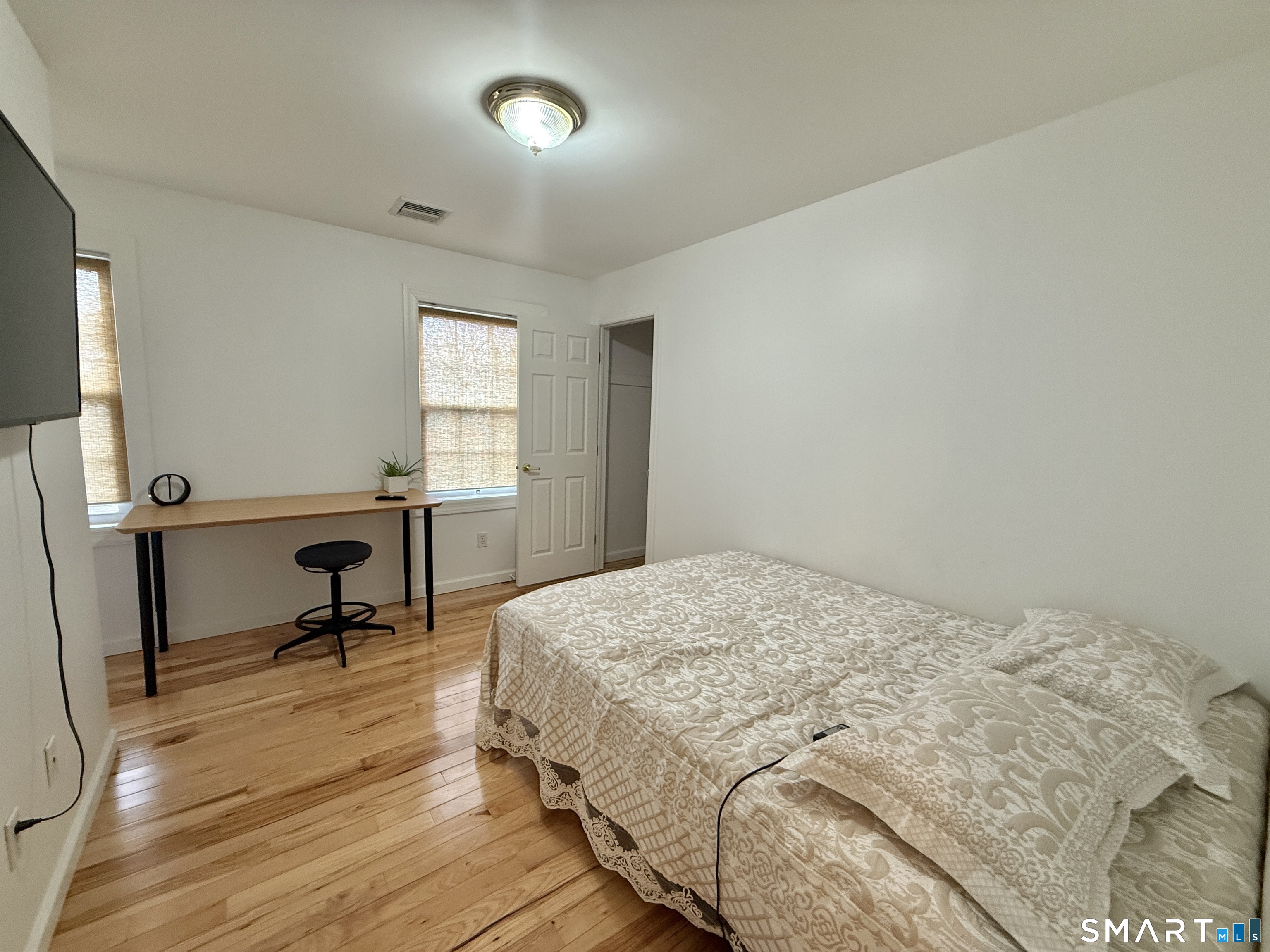 70 Renwick Place Bridgeport, CT 06604 - Photo 13 of 20 a bedroom with a bed a desk and chair