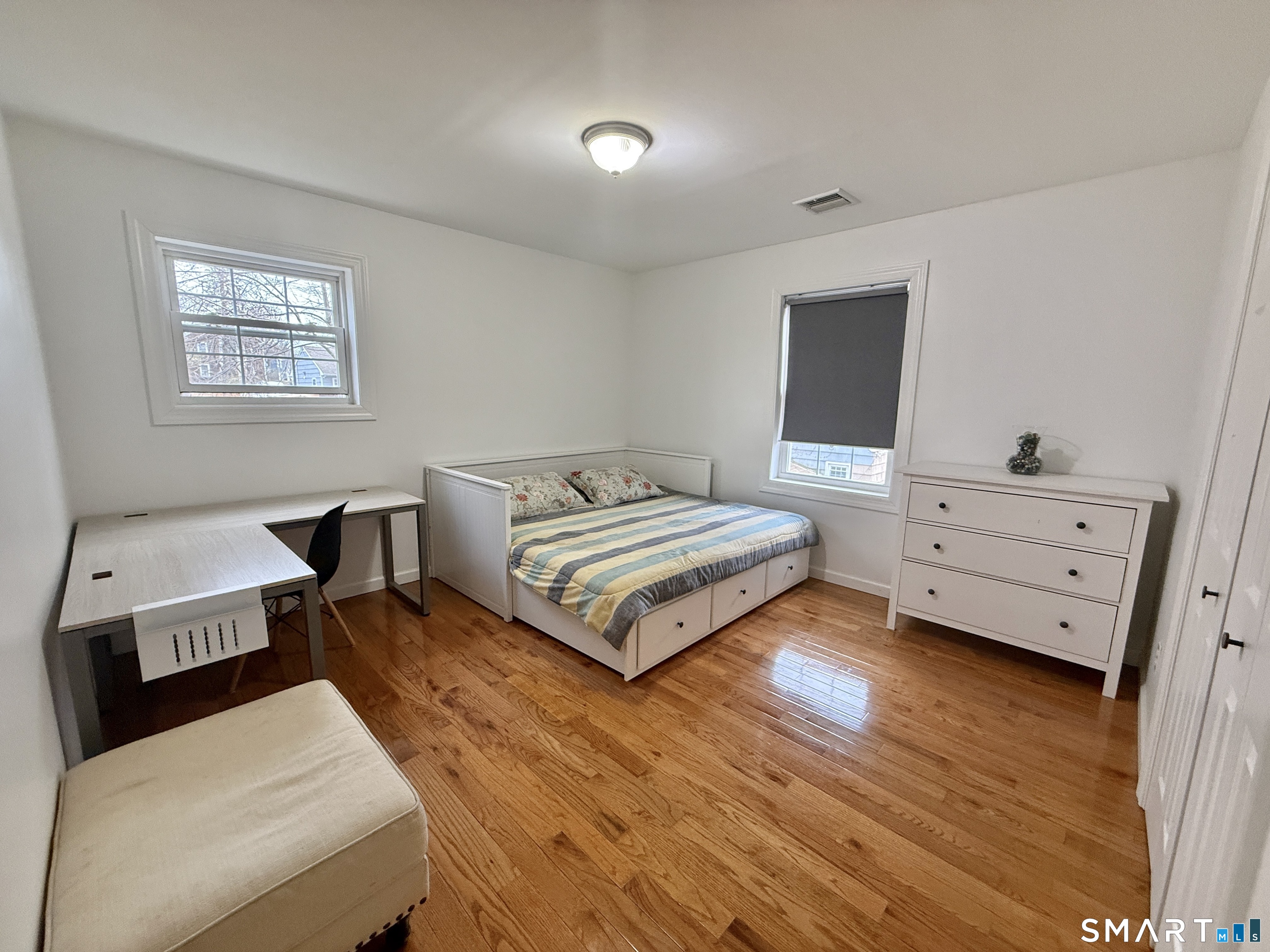 70 Renwick Place Bridgeport, CT 06604 - Photo 14 of 20 a bedroom with a bed and wooden floor
