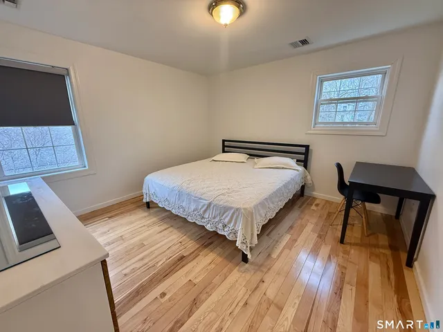 a bedroom with a bed and a table in it