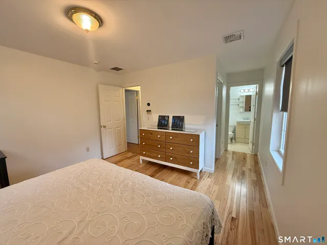 a bedroom with a bed and a mirror