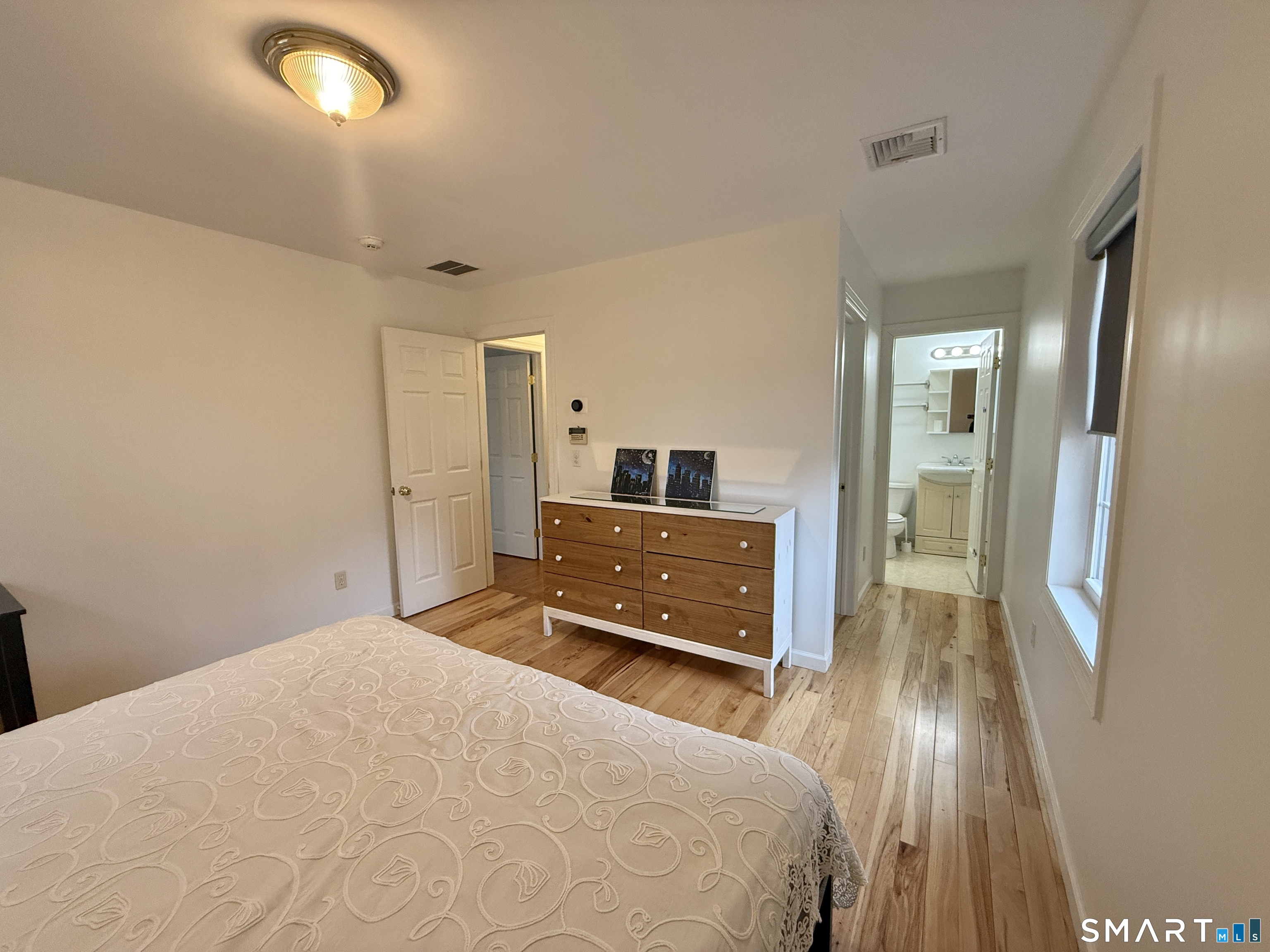 70 Renwick Place Bridgeport, CT 06604 - Photo 16 of 20 a bedroom with a bed and a mirror