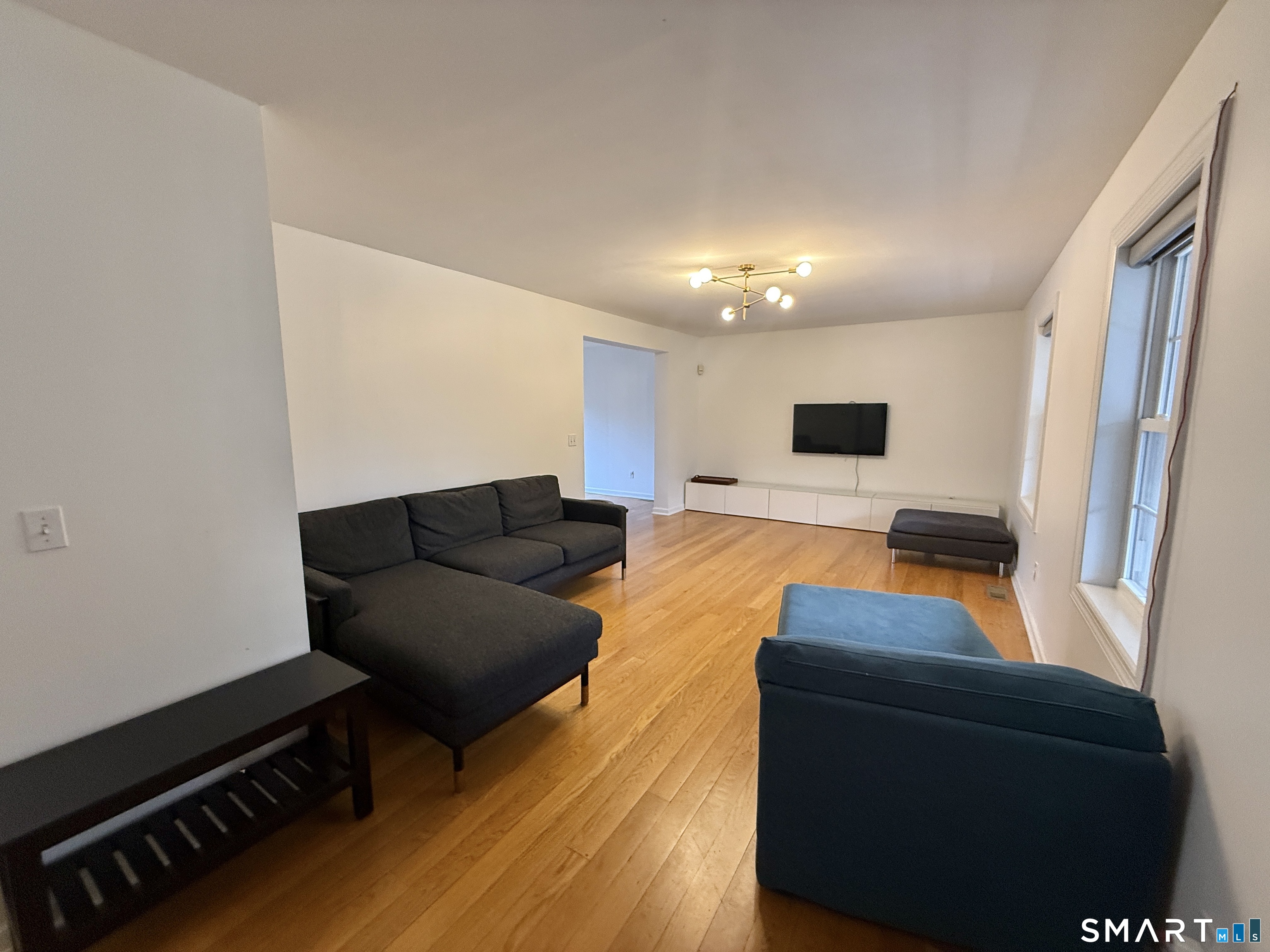 70 Renwick Place Bridgeport, CT 06604 - Photo 4 of 20 a living room with furniture and a flat screen tv