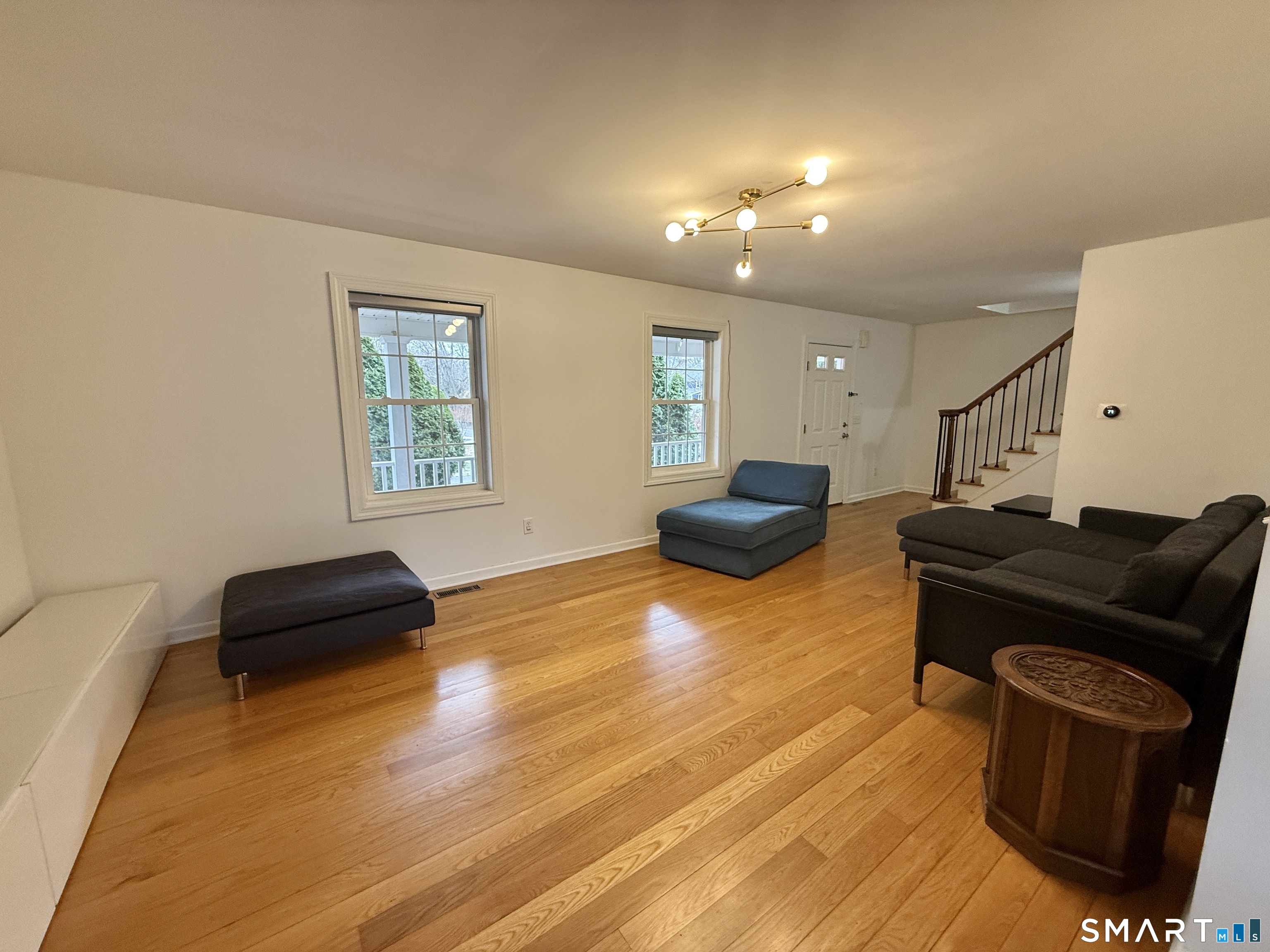 70 Renwick Place Bridgeport, CT 06604 - Photo 5 of 20 a living room with furniture and a wooden floor