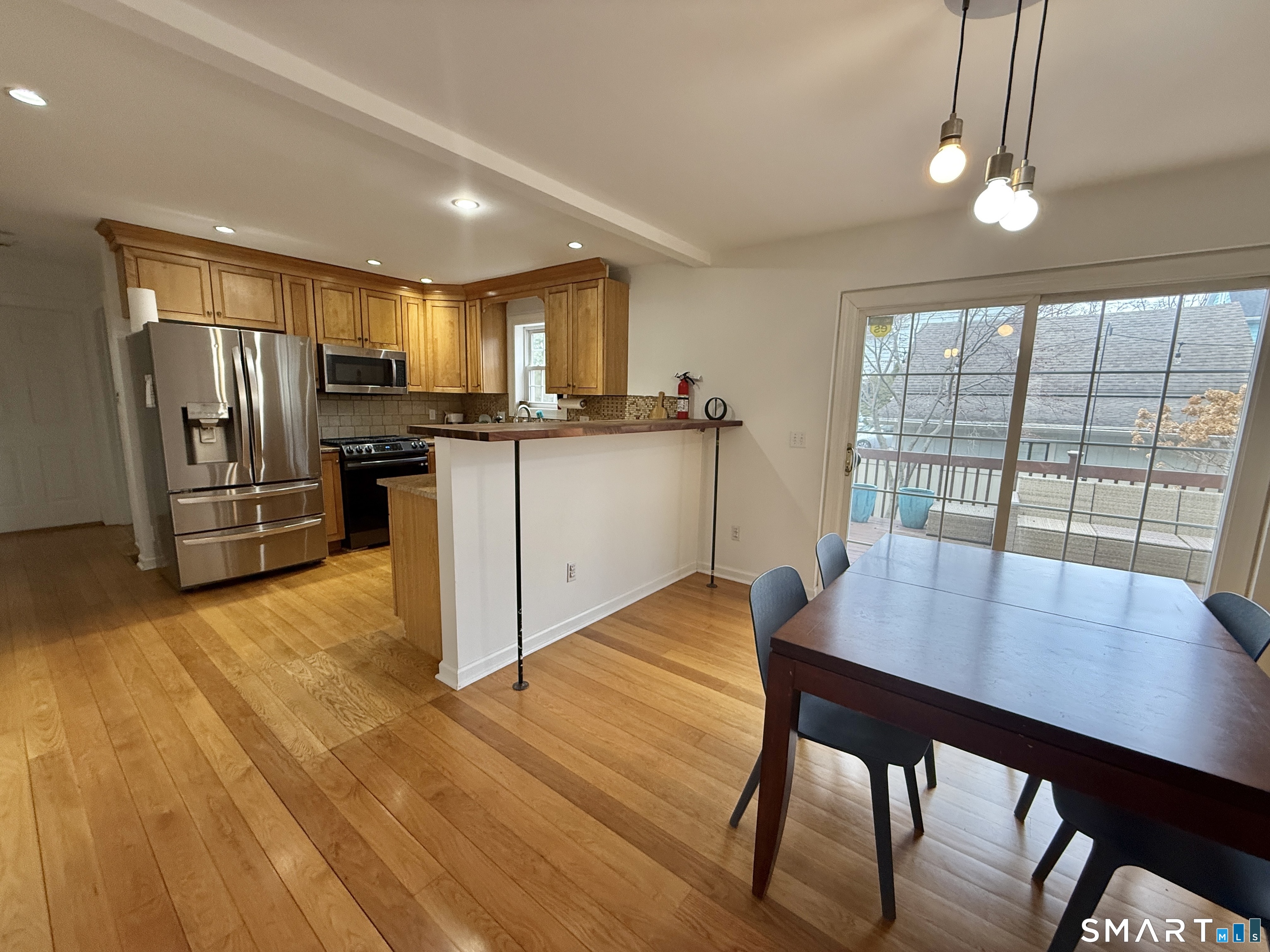 70 Renwick Place Bridgeport, CT 06604 - Photo 8 of 20 a kitchen with a wooden floor windows and chairs
