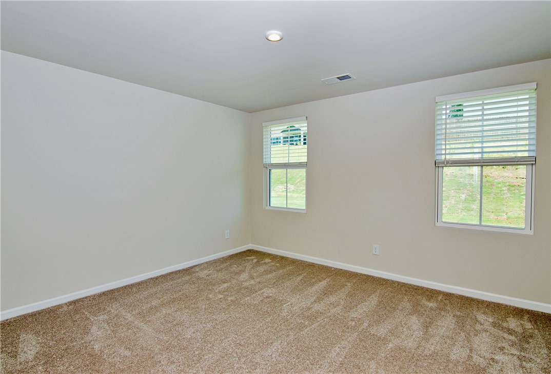 723 Peridot Way Westminster, SC 29693 - Photo 18 of 45 Well-lit and tranquil, this bedroom provides an inviting retreat with soft carpeting.