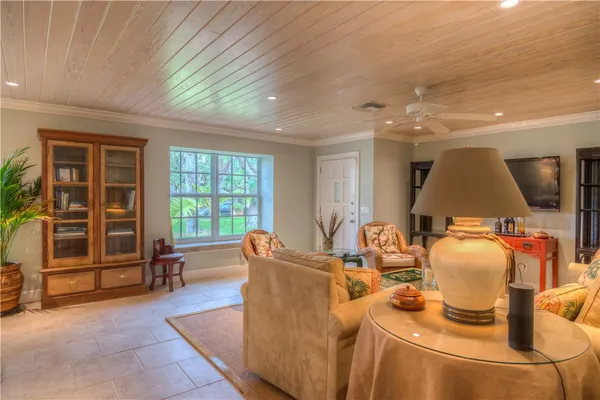 a living room with furniture a window and kitchen view
