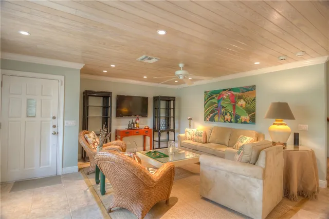 a living room with furniture and painting on the wall