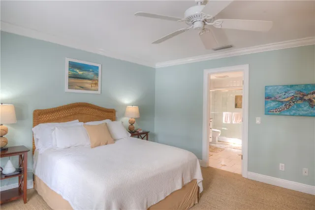 a bedroom with a bed and a painting on the wall