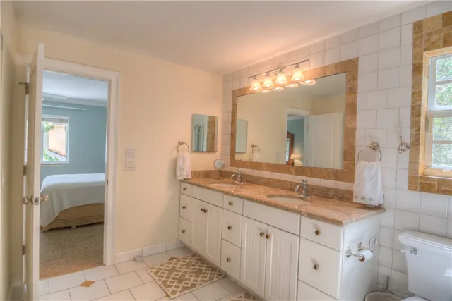 a spacious bathroom with a granite countertop sink and a mirror