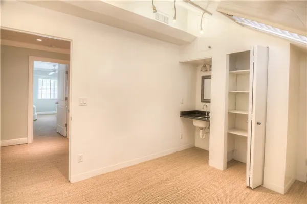 a view of empty room with a bathroom