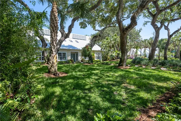 a view of house with yard and green space