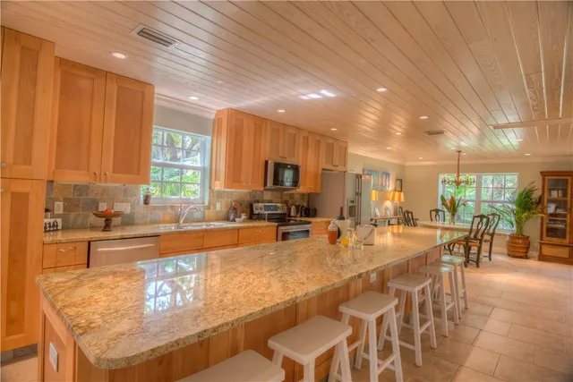 a large kitchen with lots of counter top space and stainless steel appliances