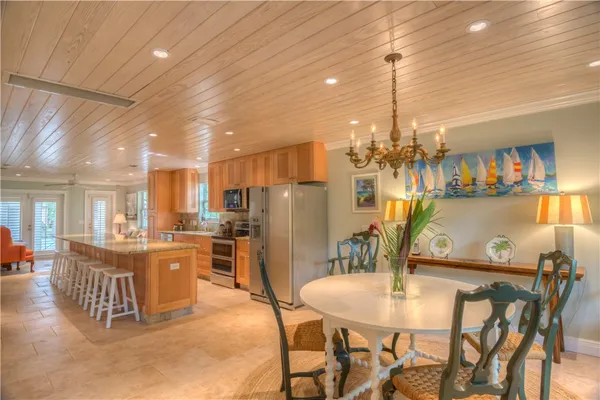 a view of a dining room with furniture and a kitchen