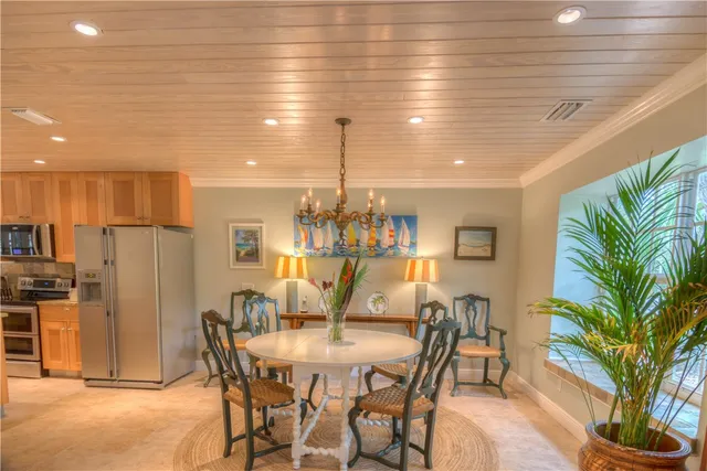 a dining room with furniture and a chandelier