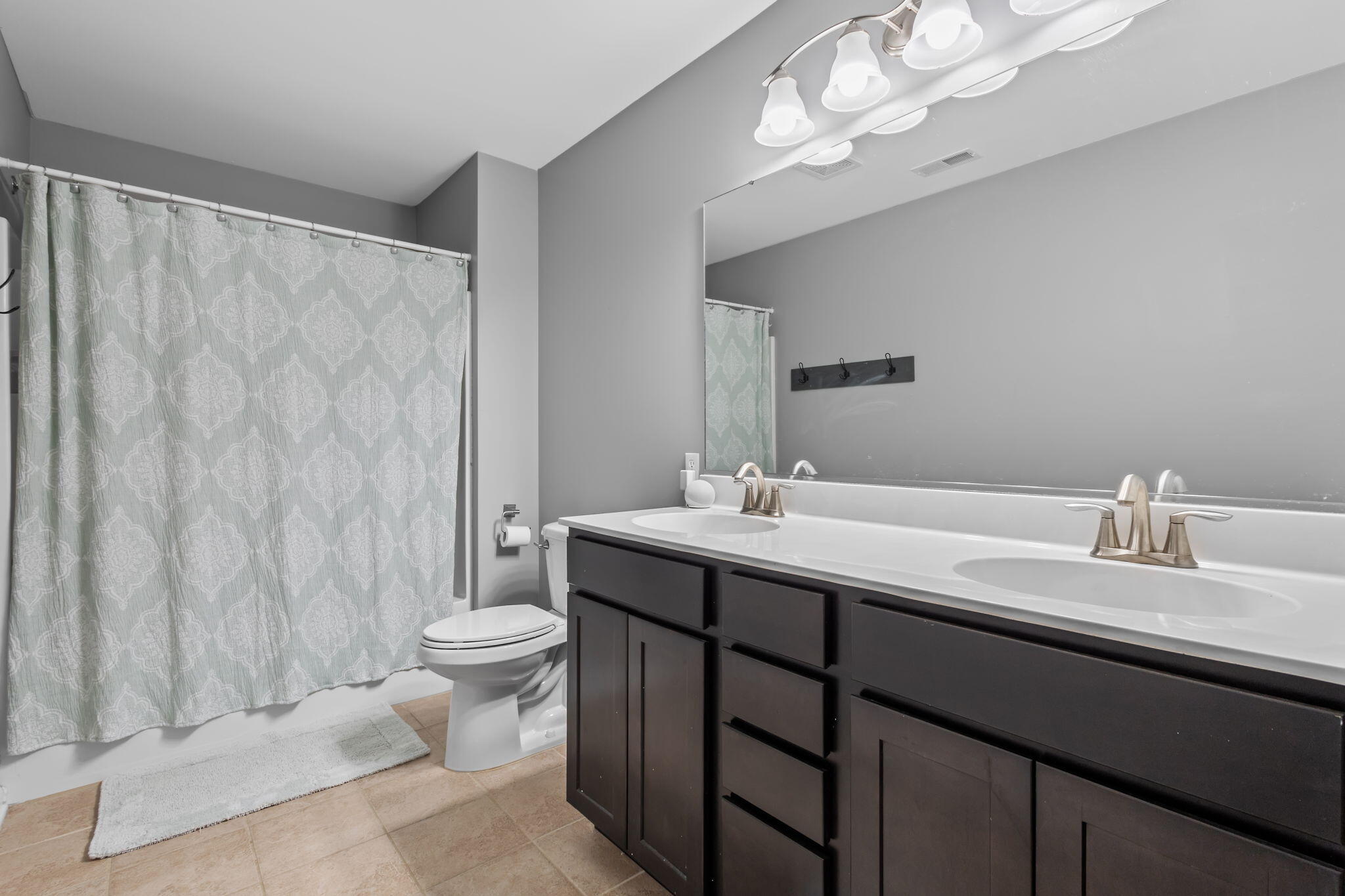 12938 Hayes Street Crown Point, IN 46307 - Photo 21 of 33 a bathroom with a double vanity sink mirror and toilet