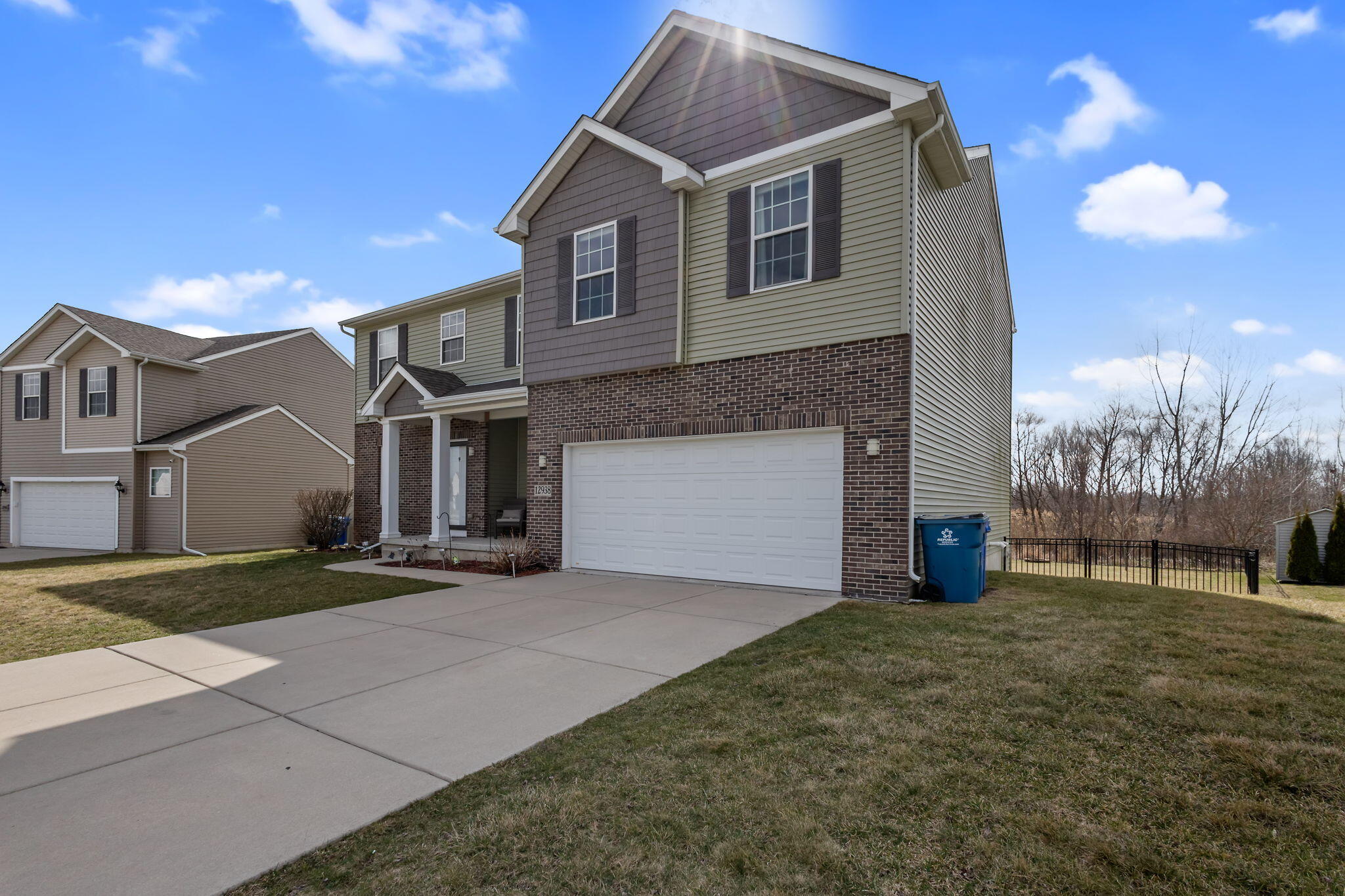 12938 Hayes Street Crown Point, IN 46307 - Photo 3 of 33 a front view of a house with a yard