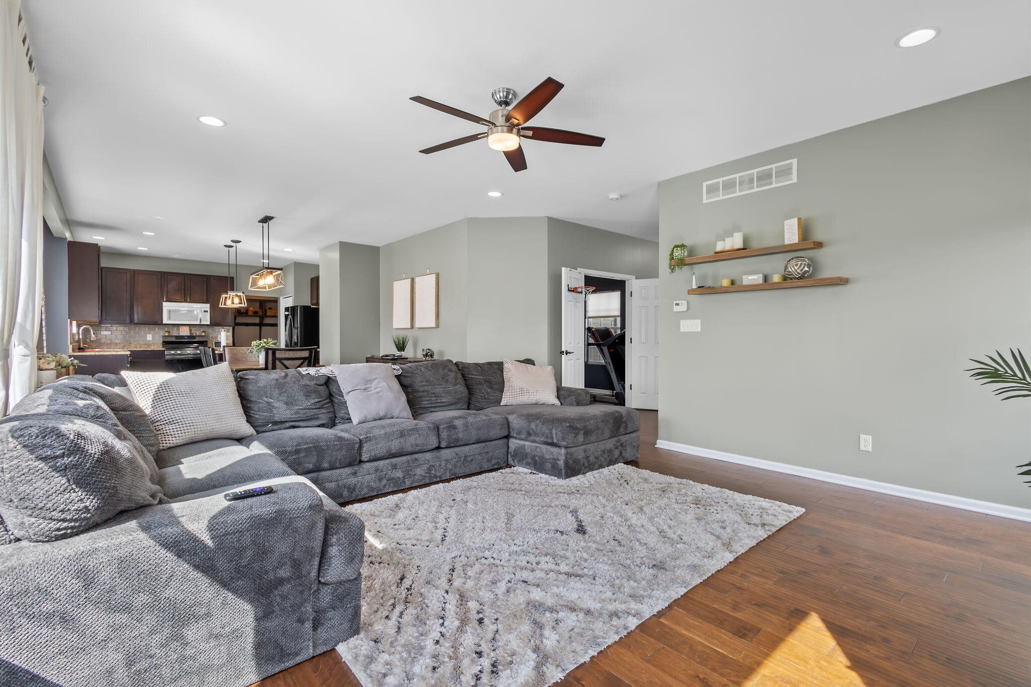 12938 Hayes Street Crown Point, IN 46307 - Photo 5 of 33 a living room with furniture and a ceiling fan