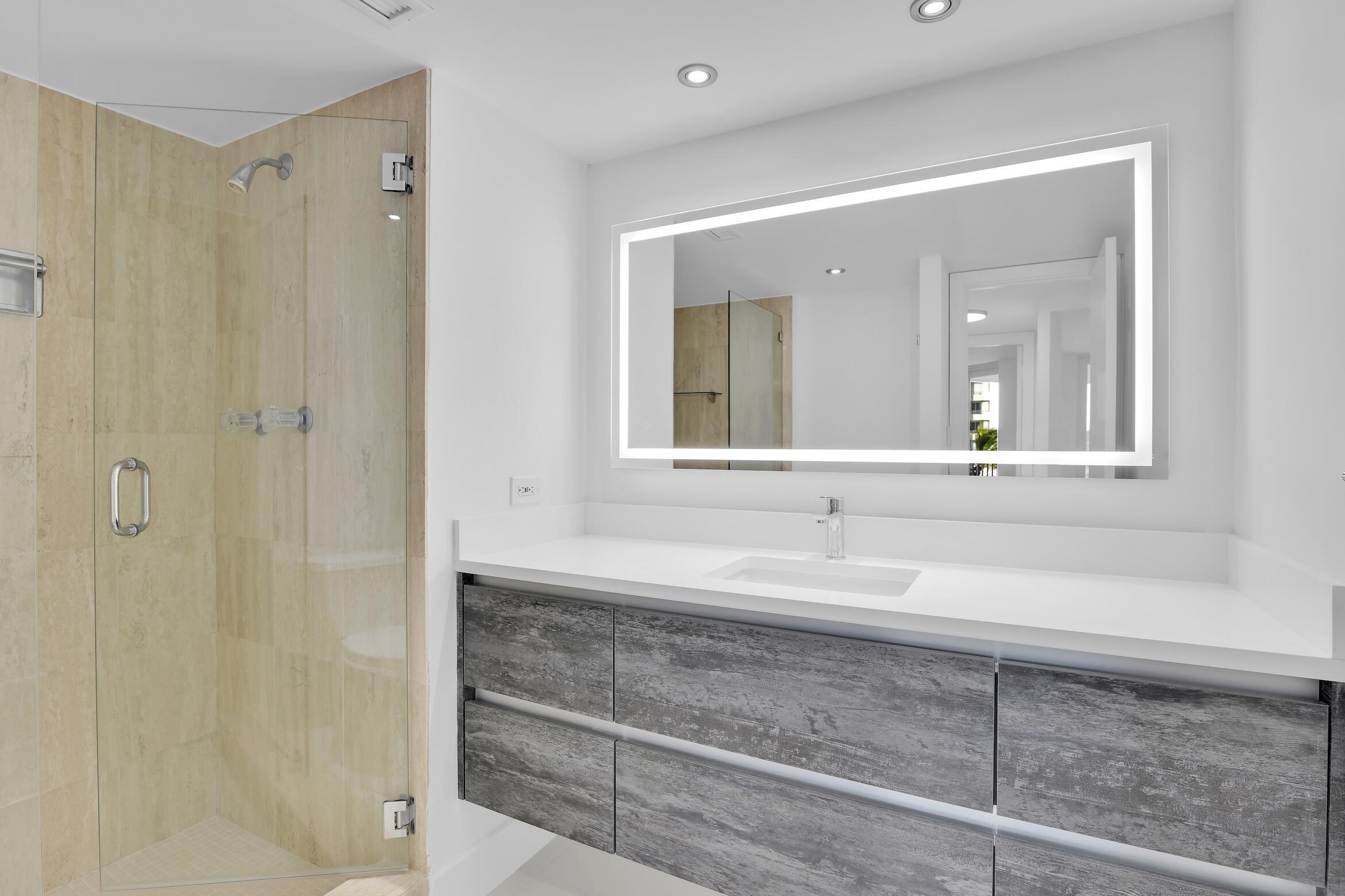 550 South Ocean Boulevard, Unit 403 Boca Raton, FL 33432 - Photo 16 of 55 a bathroom with a sink and a mirror