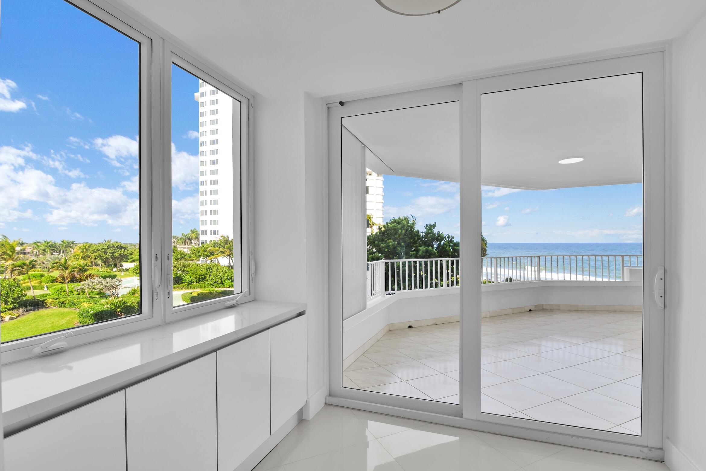 550 South Ocean Boulevard, Unit 403 Boca Raton, FL 33432 - Photo 2 of 55 a view of an entryway with wooden floor and windows