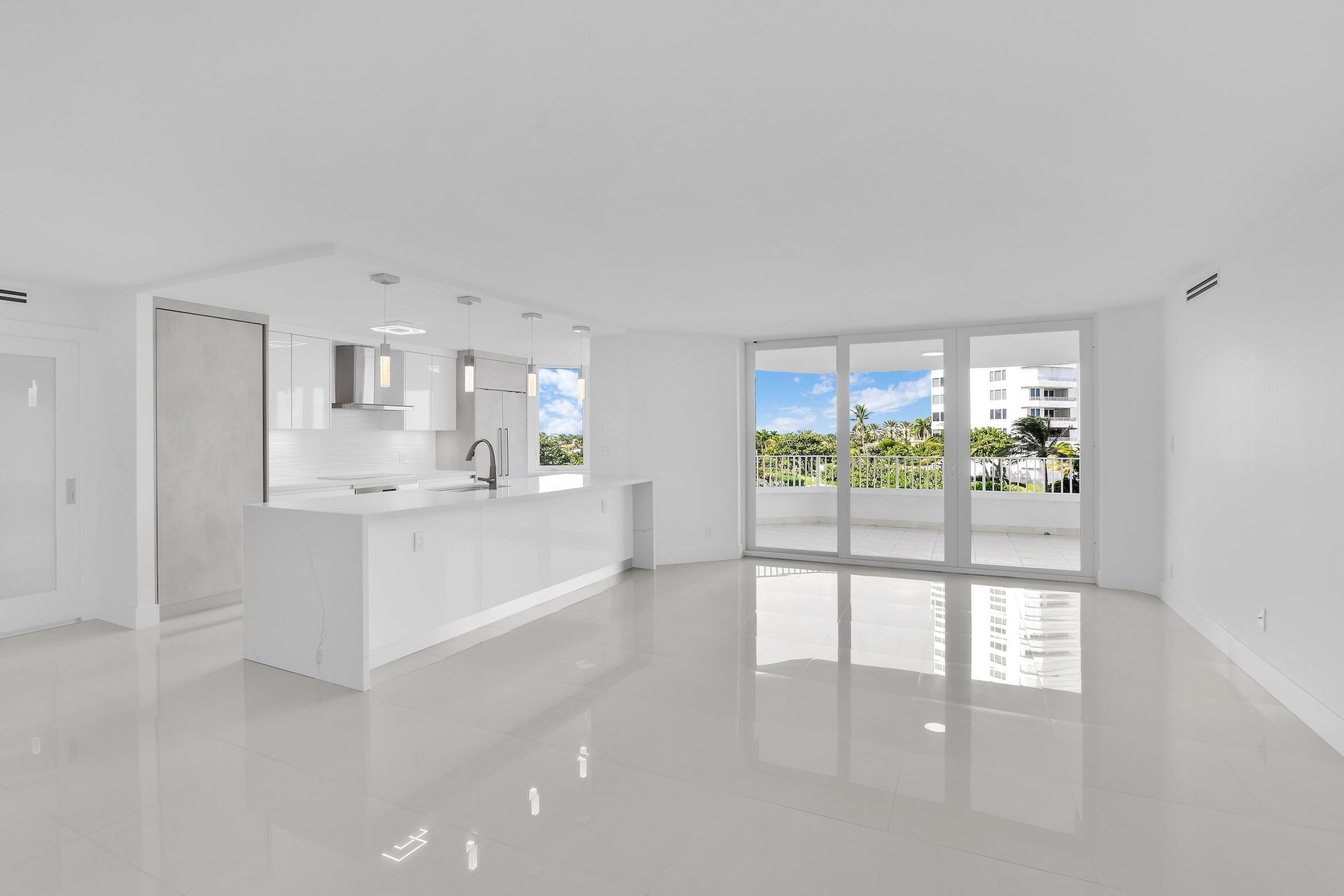 550 South Ocean Boulevard, Unit 403 Boca Raton, FL 33432 - Photo 5 of 55 a large white kitchen with a large window