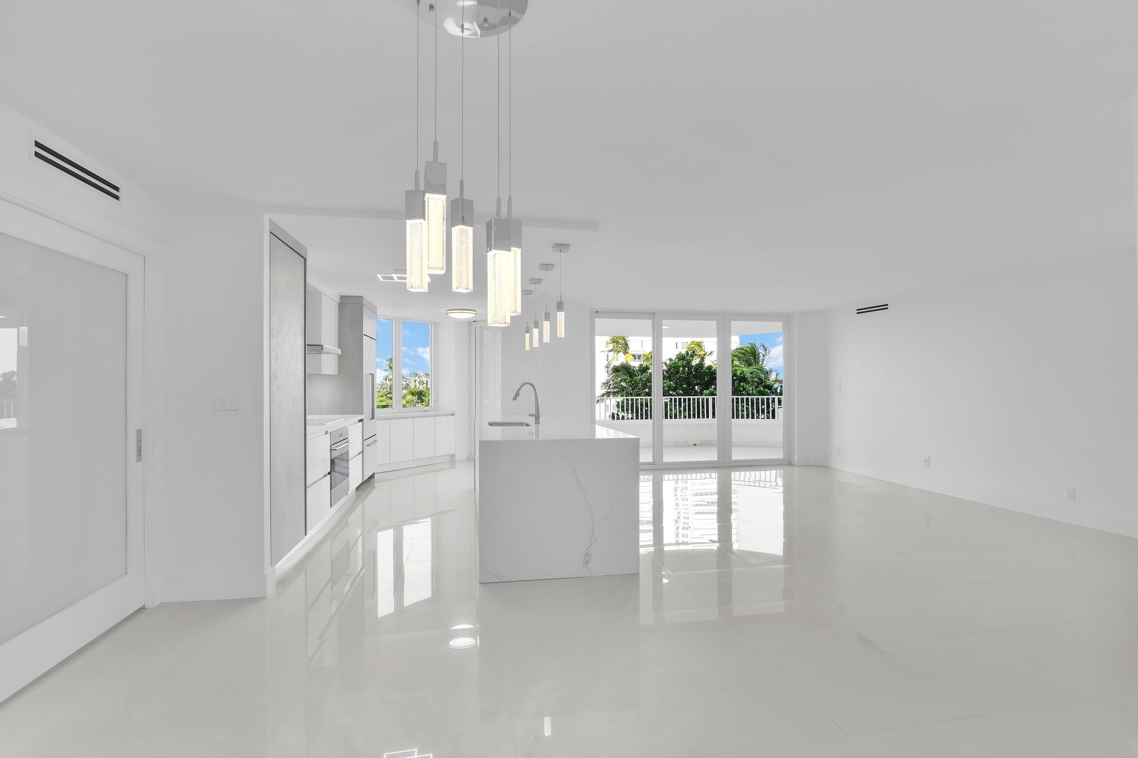 550 South Ocean Boulevard, Unit 403 Boca Raton, FL 33432 - Photo 7 of 55 a view of a kitchen and a chandelier fan