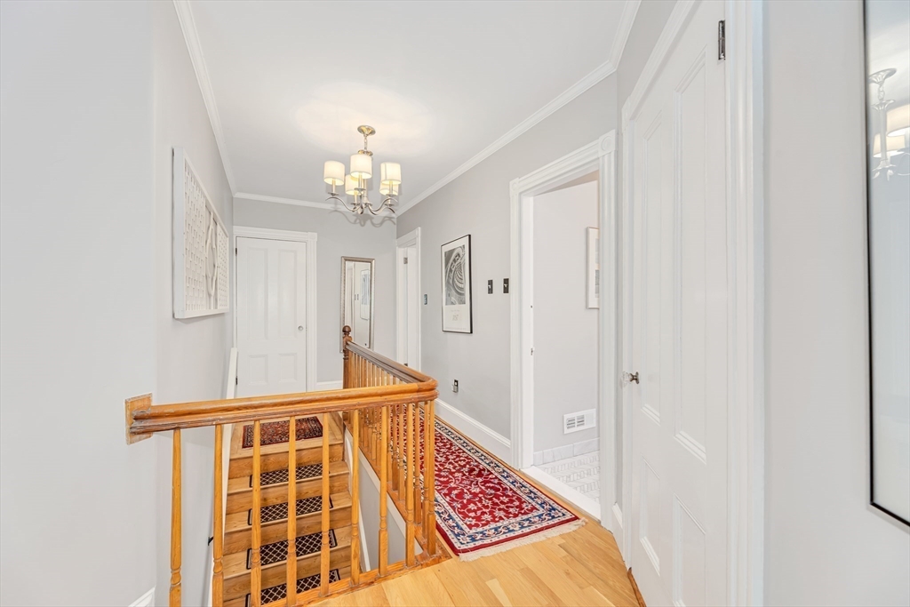 112 Perham Street Boston, MA 02132 - Photo 19 of 36 a view of a hallway with a chandelier