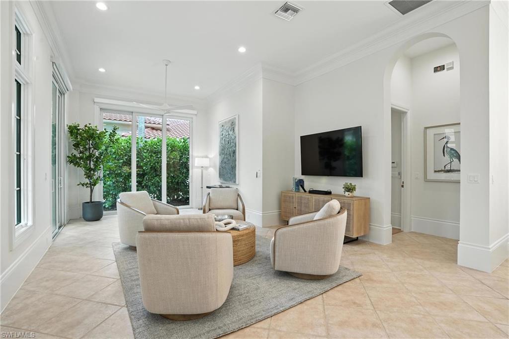 2547 Avila Lane Naples, FL 34105 - Photo 12 of 49 a living room with furniture and a flat screen tv