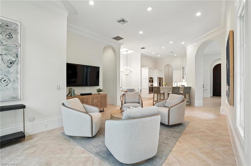 2547 Avila Lane Naples, FL 34105 - Photo 13 of 49 a living room with furniture and a flat screen tv