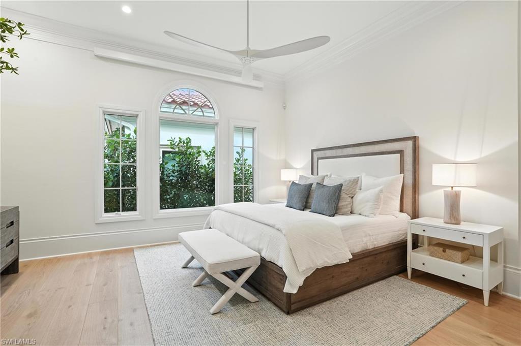 2547 Avila Lane Naples, FL 34105 - Photo 14 of 49 a bedroom with a bed and a large window