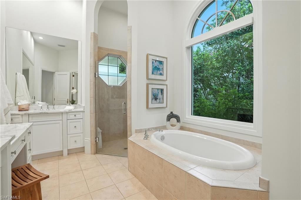 2547 Avila Lane Naples, FL 34105 - Photo 18 of 49 a bathroom with a tub sink and mirror