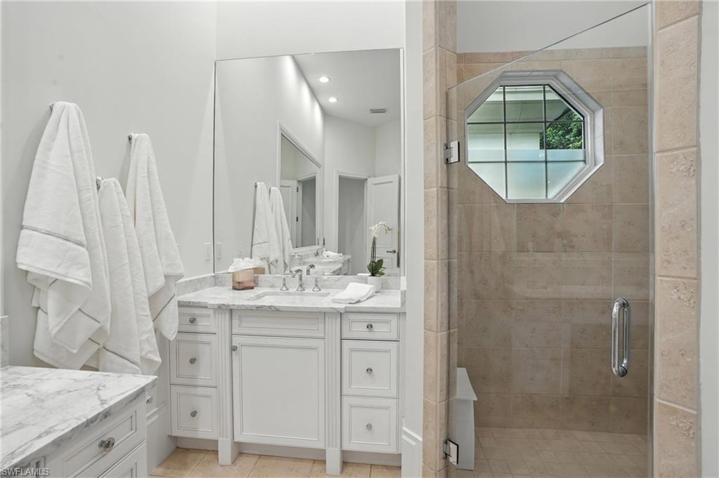 2547 Avila Lane Naples, FL 34105 - Photo 19 of 49 a bathroom with a double vanity sink and mirror