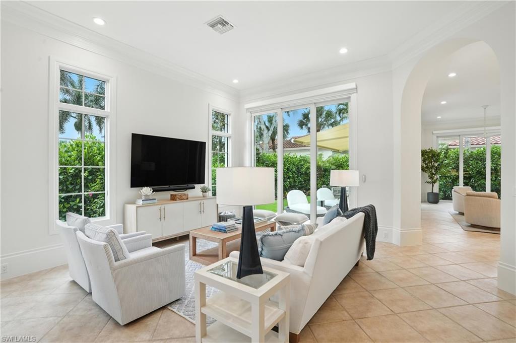2547 Avila Lane Naples, FL 34105 - Photo 2 of 49 a living room with furniture and a flat screen tv