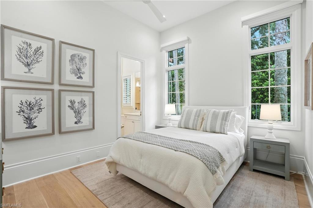 2547 Avila Lane Naples, FL 34105 - Photo 24 of 49 a bedroom with a large bed and a window