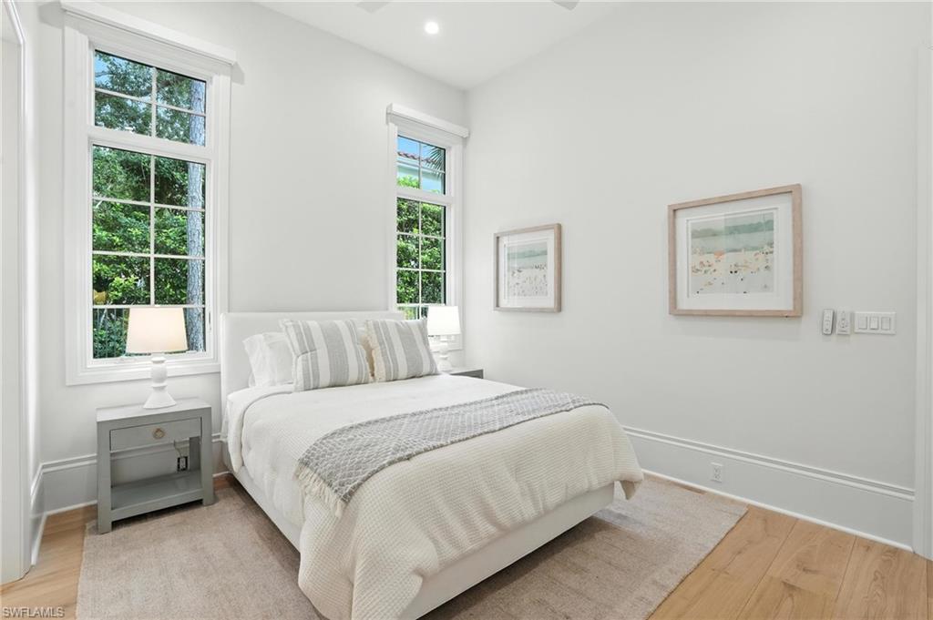 2547 Avila Lane Naples, FL 34105 - Photo 25 of 49 a bedroom with a bed and a window