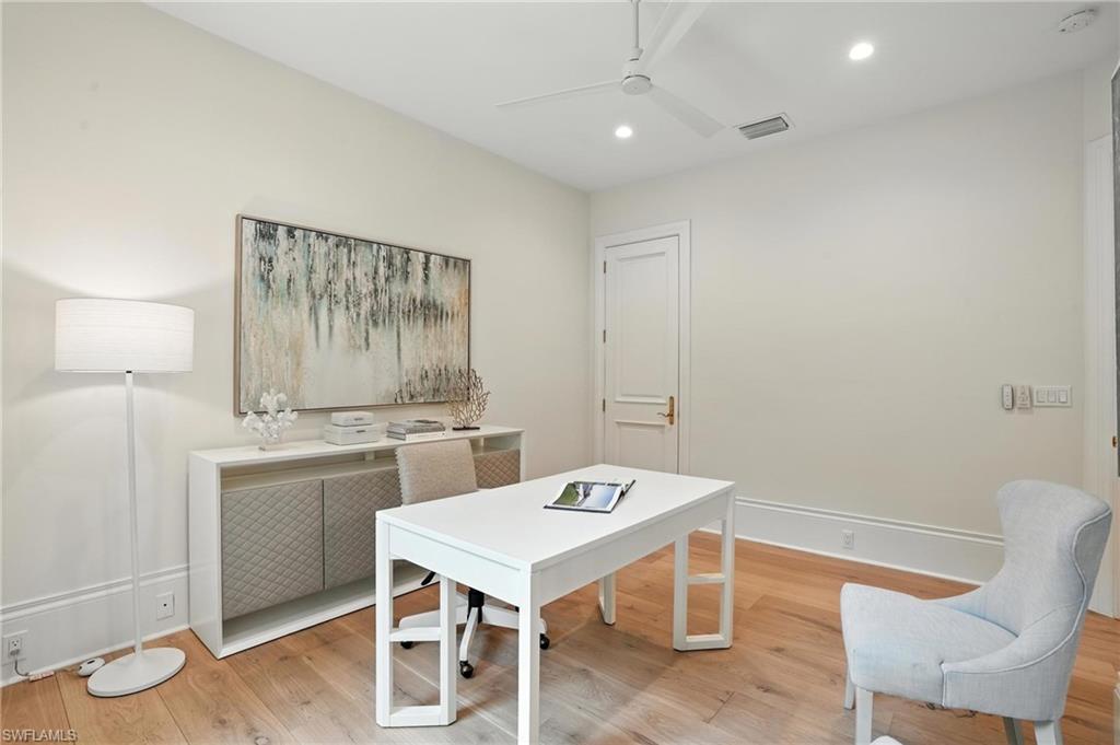 2547 Avila Lane Naples, FL 34105 - Photo 30 of 49 a view of a kitchen area with furniture and wooden floor
