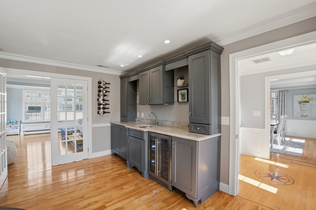 183 Whiting Street Hanover, MA 02339 - Photo 9 of 42 a view of a kitchen with kitchen island granite countertop a sink and cabinets