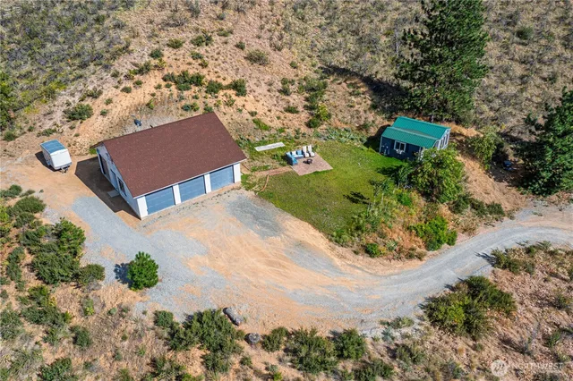 an aerial view of a house with a yard and trees