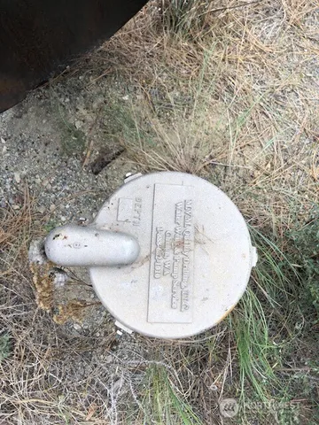 a view of a green field with wooden fence