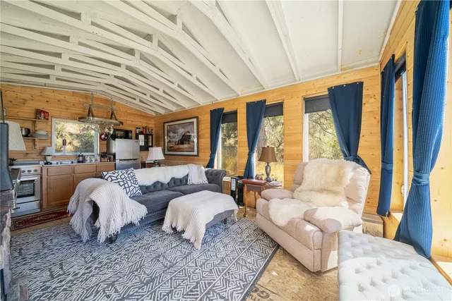a spacious bedroom with a bed and glass windows