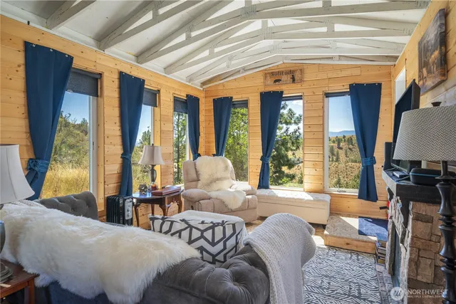 a living room with furniture and large windows