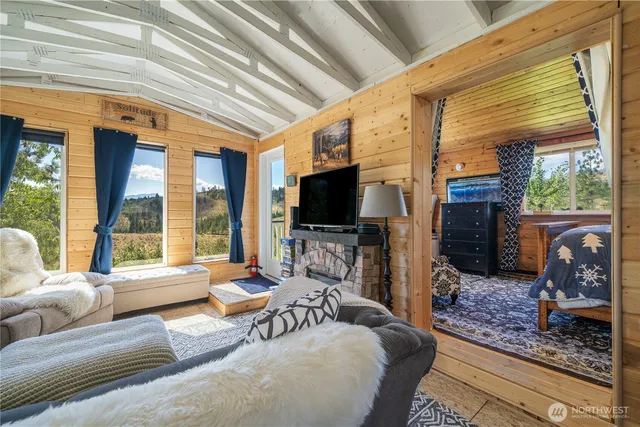a living room with furniture a flat screen tv and a fireplace