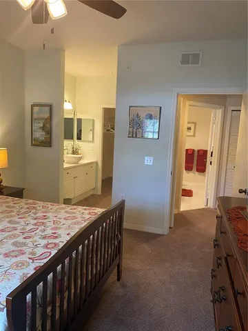 a bedroom with a bed and a dresser in it