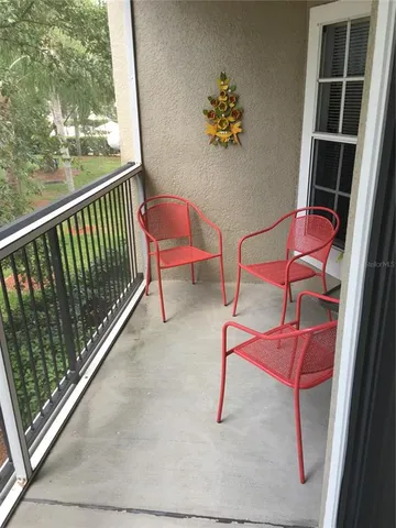 a balcony with table and chairs