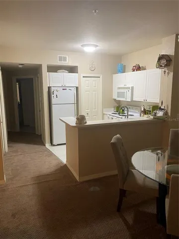 a dining room with furniture and a window